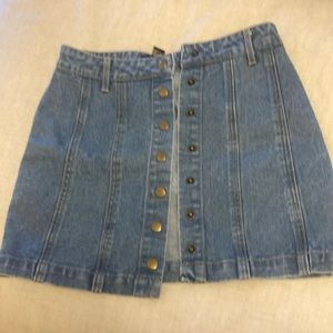 Blue jeans mini skirt with snap front. Size small. Forever 21.